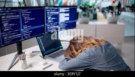 Frustrated Woman Programmer Struggles With Coding Errors Late In Office. Stock Photo