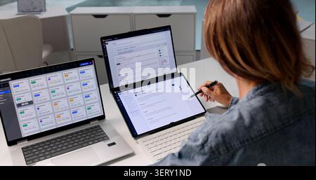 Woman Reviews AI-powered Document Retrieval System On Laptop Screen. Stock Photo