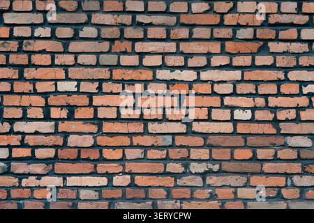 Detailed close up surface of a rugged vintage brick wall, loft style backdrop.  Old terracotta brickwork pattern, grunge architectural background. Stock Photo