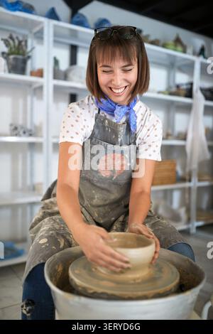 Creative young woman molding pots from clay on pottery workshop class. Creative, hobby ,workshop  concept Stock Photo
