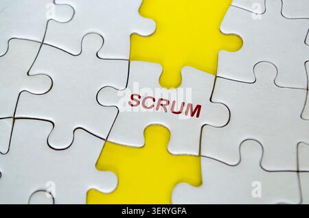 SCRUM text of white jigsaw puzzle represent a framework for collaborative project delivery. Stock Photo