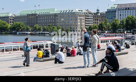 16-june-2026-hamburg-people-are-sitting-at-the-jungfernstieg-pier-on