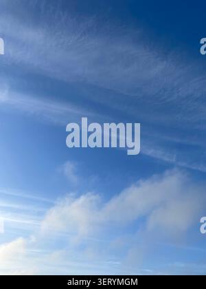 Wispy clouds in the sky Stock Photo