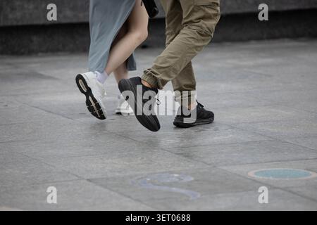 BANGKOK, THAILAND - MAY 30, 2026: Tourists in sneakers walking, high angle view. Stock Photo