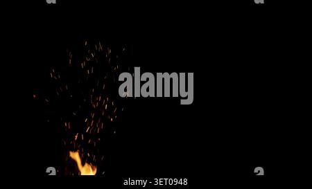 fire flames of campfire with sparks over black background, for overlay Stock Photo