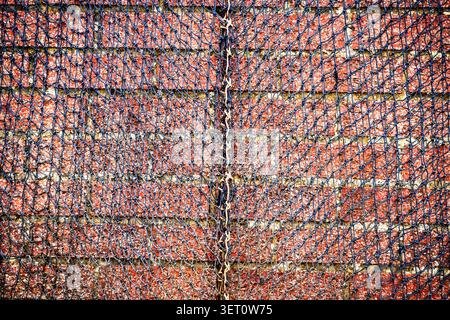 Black net draped over a brick wall abstranct background Stock Photo