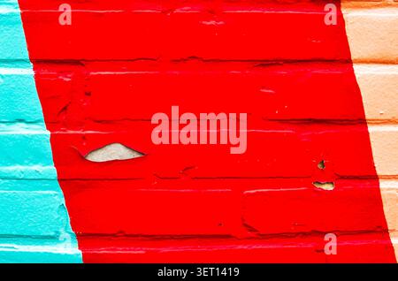 A textured brick wall with peeling paint Stock Photo