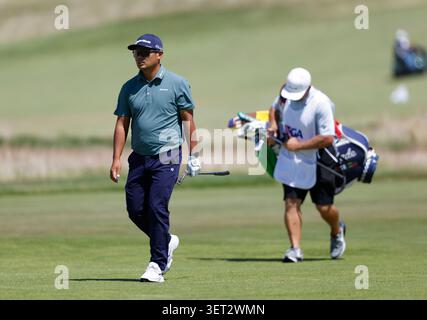 Ryo Hisatsune, of Japan, walks to the first green during the second ...