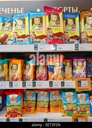 VORONEZH, Russia - March 3, 2026.A variety of Alenka sponge cakes, biscuits, and Korovka cookies are arranged neatly on supermarket shelves in a store Stock Photo