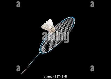 Badminton racket and shuttlecock on black background representing sport and competition Stock Photo
