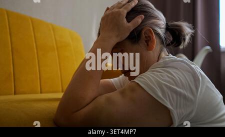 Elderly woman suffering domestic violence showing bruises Stock Photo