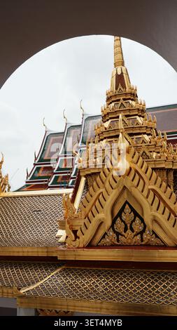 Framed View Gilded Ornate Temple Spire Seen Through Curved Arch Window Frame Stock Photo