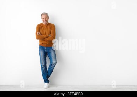 Smiling Elderly Caucasian Man Standing Confidently With Arms Crossed, Empty Space, Wellness Concept Stock Photo