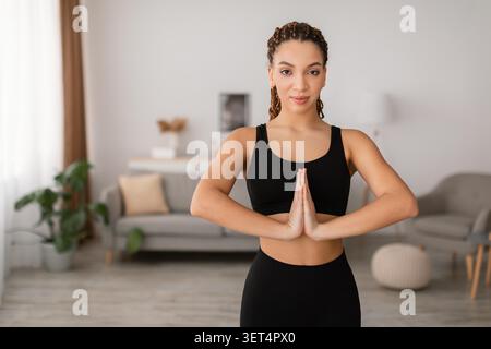Young Black Woman Practicing Yoga In Home Interior, Serenity And Mindfulness Concept Stock Photo