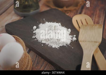 Cooking with flour and eggs on a wooden kitchen table Stock Photo