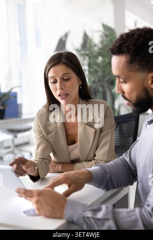 Two focused business professionals discussing or analyzing document Stock Photo