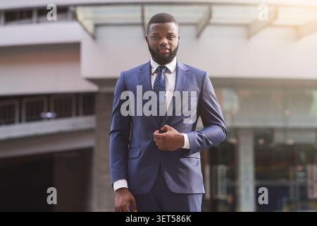 Confident black businessman in stylish suit looking at camera Stock Photo
