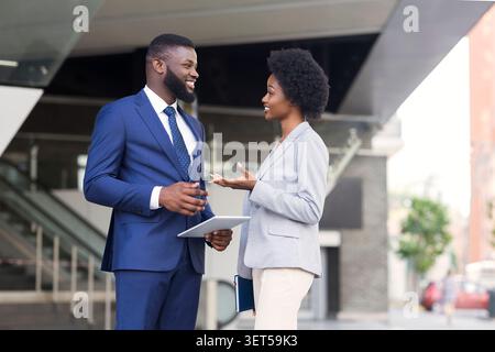 Attractive african coworkers having pleasant chat together Stock Photo