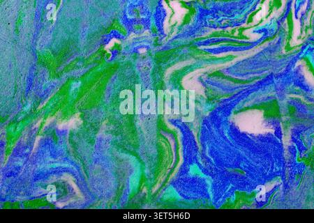Fluid paint creating an abstract swirled texture and pattern Stock Photo