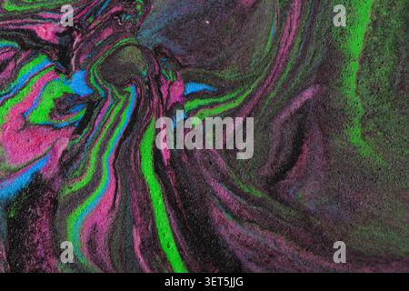 Vibrant swirling liquid creating an abstract colorful background with paint texture Stock Photo