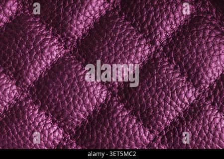 Close up, macro of pink quilted leather texture with stitched diamond pattern, luxury material surface shining metal effect for fashion, upholstery or Stock Photo