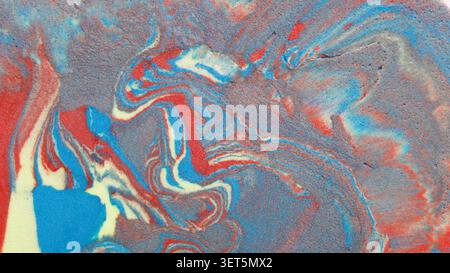 Marbled clay mixture forming an abstract textured background with red and blue swirls Stock Photo