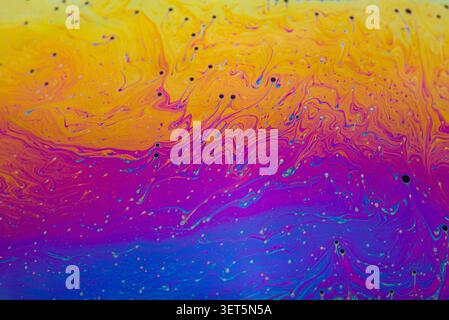 Soap bubble film creating an abstract background of vibrant, colorful, textured patterns Stock Photo