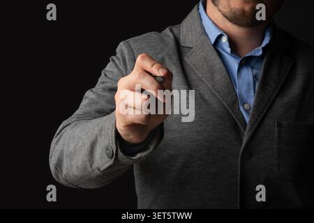 Person Holding a Pen and Ready to Write While Dressed in a Formal Outfit Stock Photo