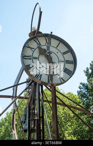 Close-up of an ancient iron clock tower on a sunny summer day Stock Photo