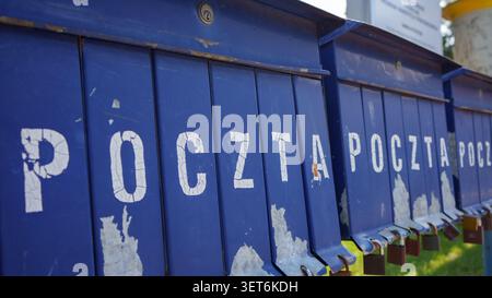 Old blue mailboxes with Polish word Poczta meaning Post and padlocks Stock Photo