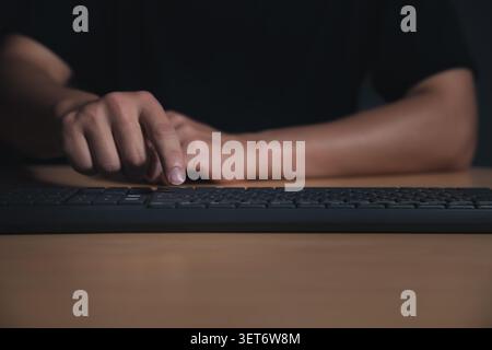 Closeup shot of man hand pressing enter key on computer keyboard. Stock Photo