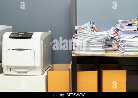 Business documents stack on table. report papers stack and printer in office. Stock Photo