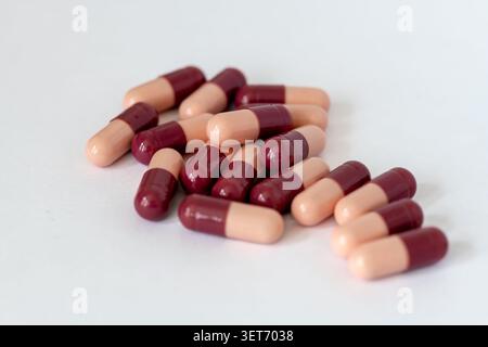 A pile of loose medicine capsules isolated on white. Stock Photo