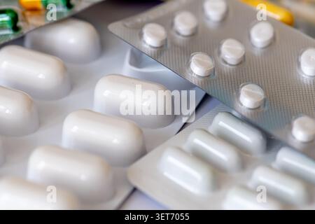 A macro close up of medicine tablets and capsules in blister packs. Stock Photo