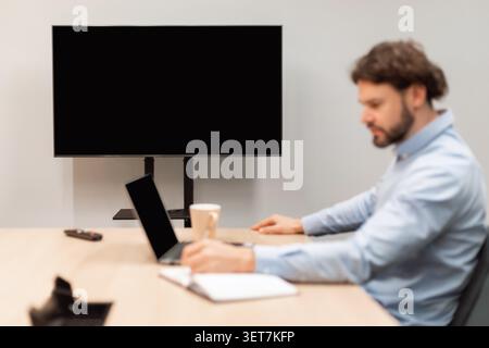 Unrecognizable Man Working On Laptop Taking Notes In Office, Business Concept Stock Photo