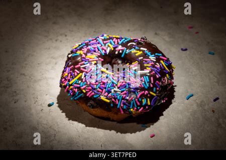 Doughnut with party sprinkles on a white background top down view Stock Photo