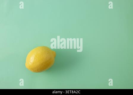 Lemon on pastel green background. Minimal nature concept. Fruit flat lay. Stock Photo