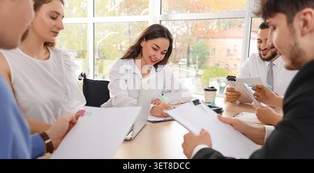 Diverse business team collaborating on project in modern office, inclusive workplace meeting with colleagues Stock Photo