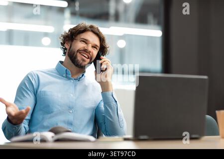 Smiling Bearded Caucasian Man Speaking On Phone In Office, Modern Business Concept Stock Photo