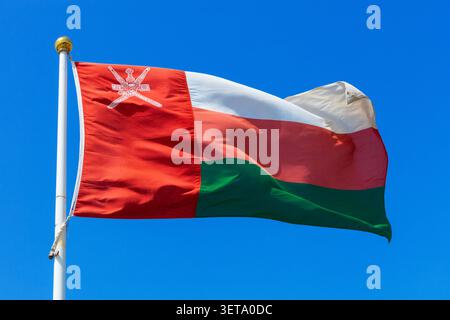 The flag of Oman flying proudly over the Ras Al Jinz Turtle Reserve in Oman Stock Photo