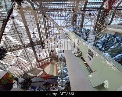 Interior view of the glass atrium roof and escalator column at St. Enoch Shopping Centre, Glasgow, Scotland. Stock Photo