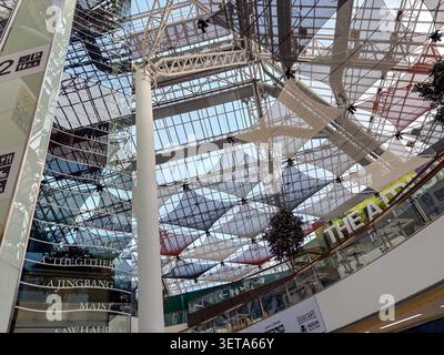 Modern architectural glass roof structure at St. Enoch Shopping Centre in Glasgow, Scotland, featuring geometric fabric shade panels. Stock Photo