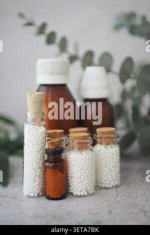 Bottles and jars of homeopathic remedies on a table Stock Photo