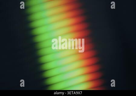 Abstract rainbow light refraction through ribbed glass, modern gradient background Stock Photo