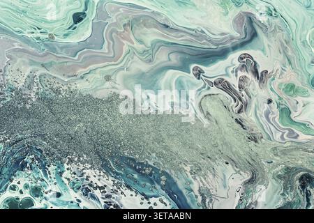 Fluid art acrylic paints. Abstract mix of teal waves. Fluid flows, splashes. background or texture with marble effect Stock Photo