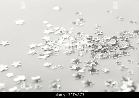 Silver star shaped confetti that creates a festive backdrop â€œColor of the Yearâ€ concept Stock Photo