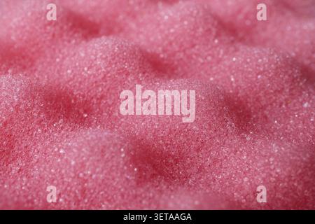 Pink textured sponge with porous foam and wavy surface Stock Photo