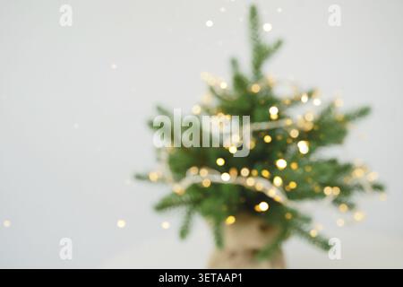 Blurry Christmas tree with twinkling lights in soft focus Stock Photo