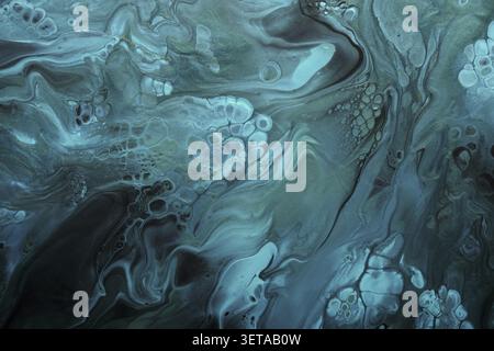 Liquid art. Metallic green and blue abstract waves with golden particles on a black background. background or texture with marble effect Stock Photo