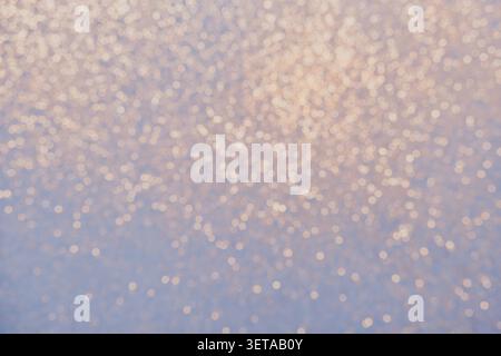 Blue background with golden glitter lights Blurred abstraction in winter Stock Photo